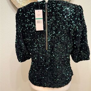 This is a dark green sequined tops with a zipper in the back